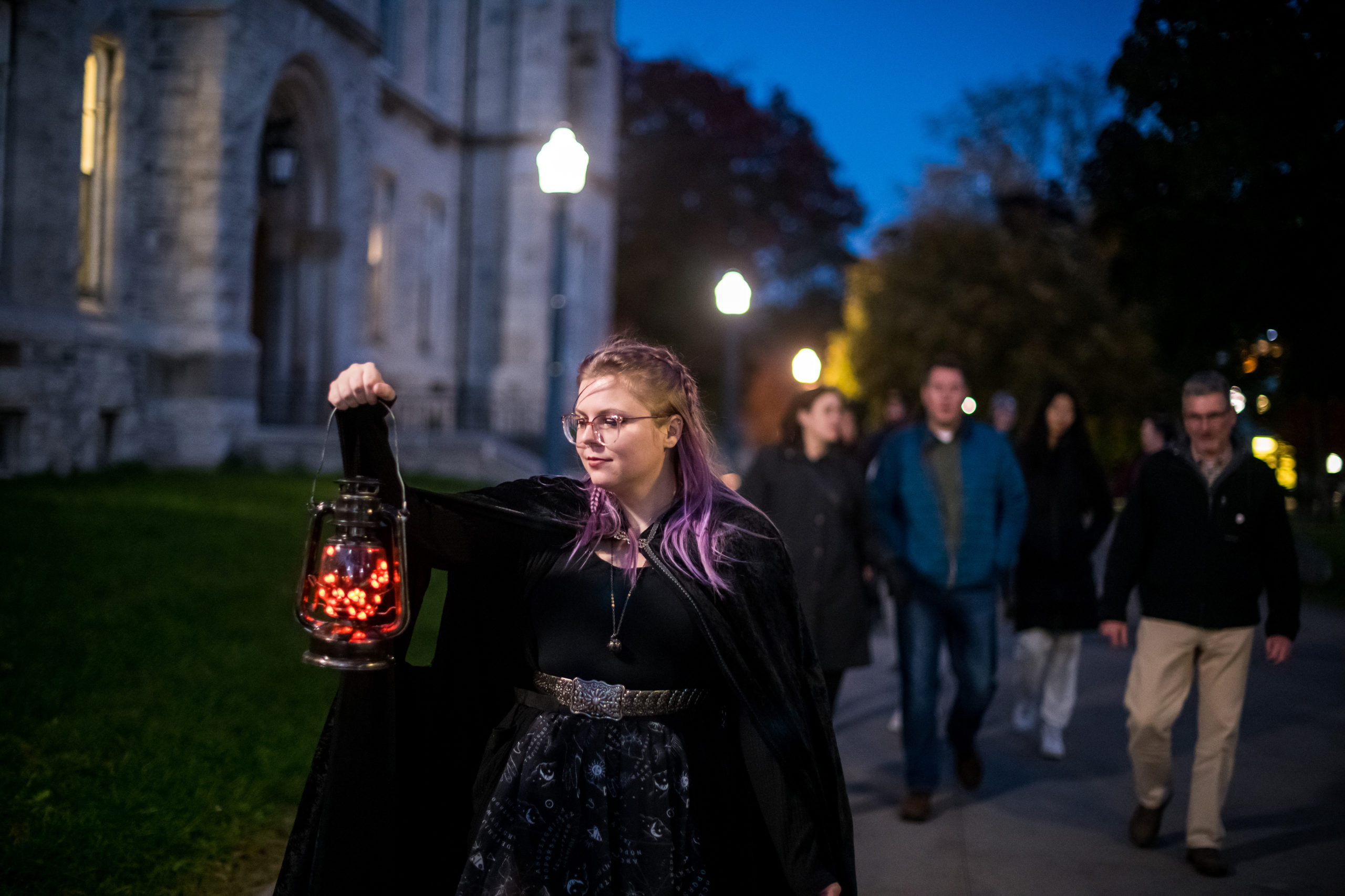 Haunted Walk guide holding a lantern guiding people