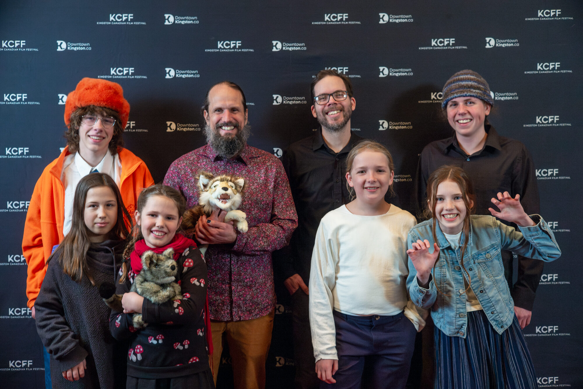 A group of adults and children smiling on the Slaight Music Video showcase red carpet.